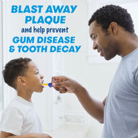 Father brushing the teeth of his son with a Clean N' Protect Transformers Toothbrush. Blast away plaque and help prevent gum disease and tooth decay